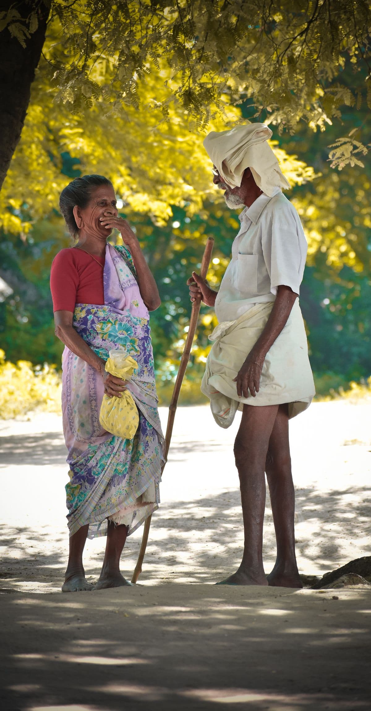 An elder Desi couple smiling